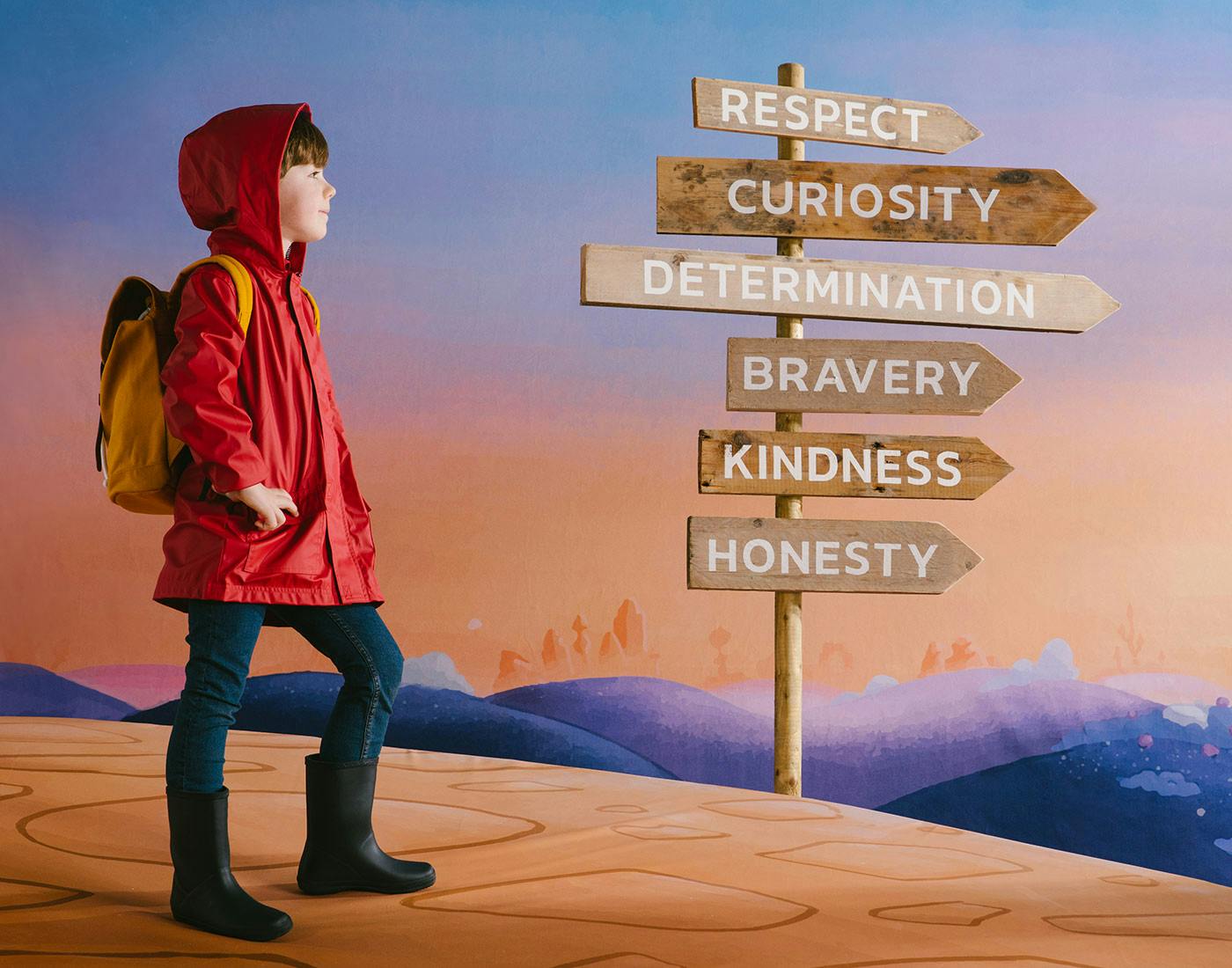 The Wondrous Road Ahead, child on a path with multiple sign posts for Respect, Curiosity, Determination, Bravery, Kindness and Honesty