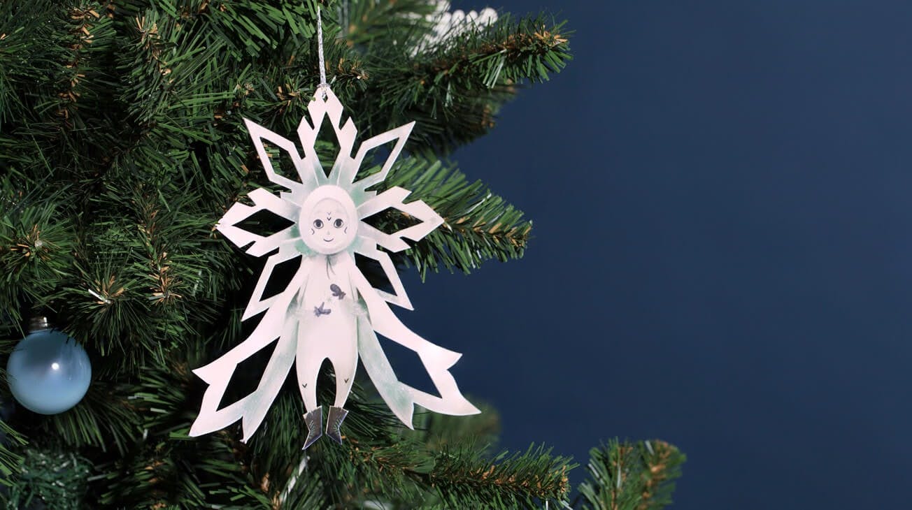 The Christmas Snowflake ornament hanging from a christmas tree